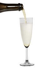 Champagne from a dark bottle pours into a glass with a lot of foam. Isolated on a white background