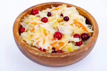 Sauerkraut with red cranberries in wooden bowl. Studio Photo