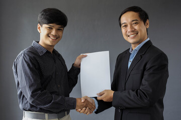 The boss giving his employees certificates and congratulations for reward and they looking to camera