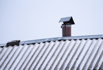 a chimney on an old roof against the sky