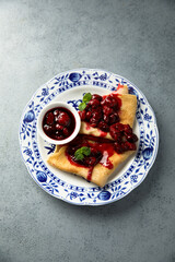 Homemade crepes with hot cherry sauce