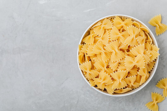 Farfalle Pasta. Uncooked pasta shapes. Raw organic Italian farfalle pasta in bowl