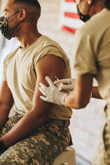 Young serviceman getting vaccinated against coronavirus disease