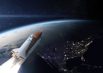 Space shuttle orbiting Earth planet. Elements of this image furnished by NASA.