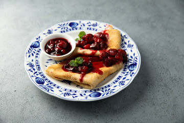Homemade crepes with hot cherry sauce