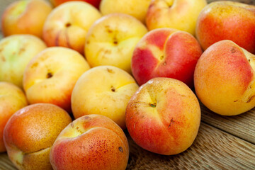 Naklejka na ściany i meble Delicious ripe apricots fruit on wooden surface close up