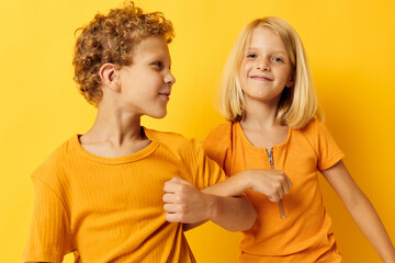 picture of positive boy and girl casual wear games fun together posing on colored background