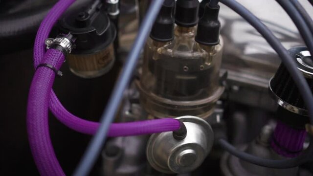 Working engine. Footage. Ignition spark distributor with transparent cover. View under the hood