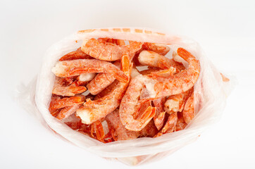 Frozen pink headless shrimp on white. Studio Photo - obrazy, fototapety, plakaty