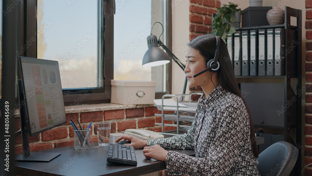 Poster worker at customer service using microphone on phone call. sales assistant having conversation with 