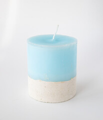 Wedding decoration with big blue candle on the white background One Elegant Blue Hand made Candle on Concrete Stand Home Decor Details. Flare Copy space Close-up Vertical image