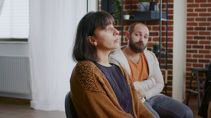 Woman sharing sad story with people and psychologist at aa group therapy session. Person dealing...