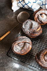 Chocolate cruffin, a hybrid of a croissant and muffin with a lot of butter, sprinkled with powdered sugar.