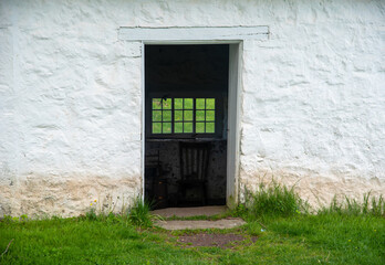 View through open doorway in colonial American stone springhouse