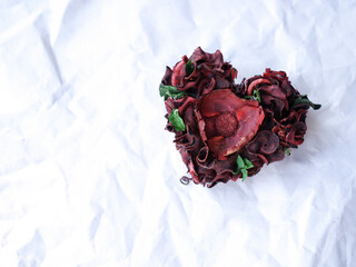 heart from dried flowers on a white background