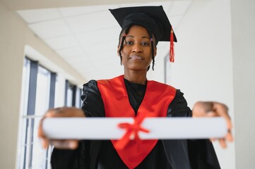 beautiful young afro american graduate holding diploma