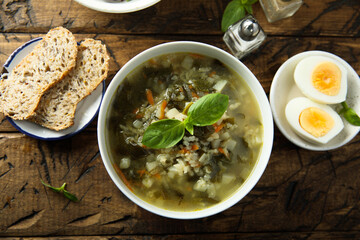 Traditional homemade green soup with hard boiled eggs