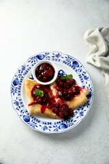 Homemade crepes with hot cherry sauce