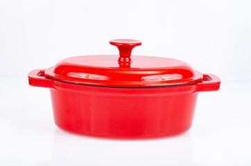 Red ceramic cast iron casserole dish. Studio Photo