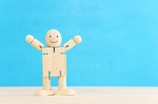 Concept image of happy mind and positive thinking. Wooden figure with smiling face