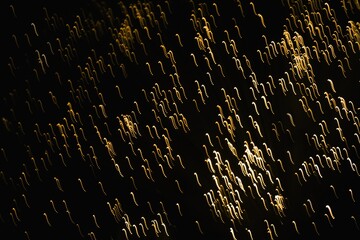 Fototapeta premium Abstract blurred golden glittering light on the black background