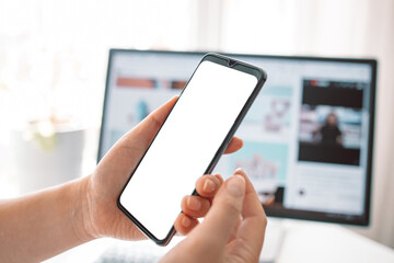 Professional business woman hand holding phone with white screen of smart phone. Female holding smartphone with white screen. Hand with blank cellphone display