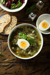 Traditional homemade green soup with hard boiled eggs