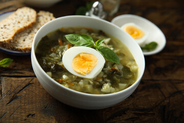 Traditional homemade green soup with hard boiled eggs