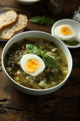 Traditional homemade green soup with hard boiled eggs