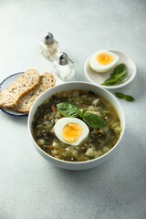 Traditional homemade green soup with hard boiled eggs