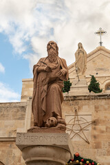 Fototapeta premium Statue of Saint Jerome in front of the entrance to Chapel of Saint Catherine, near to the Church of Nativity in Bethlehem in the Palestinian Authority, Israel