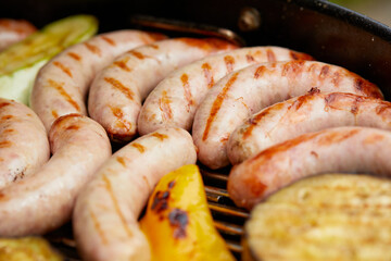 Delicious assortment of meat neck steak and vegetables grilling on a BBQ
