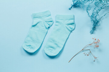 Pair of women socks on blue background.