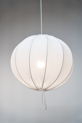 Obraz premium White modern pendant lamp, fabric spherical chandelier in Scandinavian style on grey background