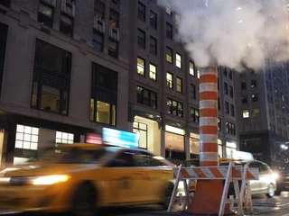 Foto auf Leinwand Long exposure image of a cab passing by a steam stack in New York. © Alexandre