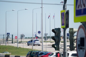 Traffic light and road sign pedestrian crossing close-up, blurry