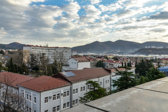 white clouds over roofs of houses and foothills of Northern Caucasus in Tuapse (Krasnodar krai, Russia) 