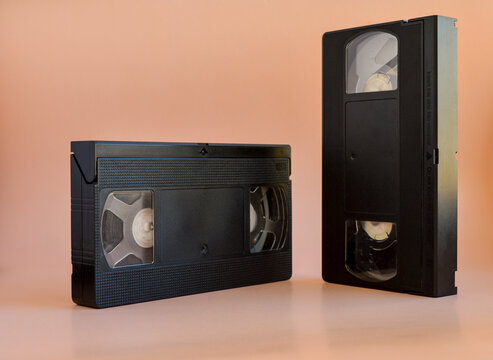 Two old black vintage vhs cassette tape, cut out 80s, 90s retro media aesthetic, magnetic videotape movie storage concept studio shot