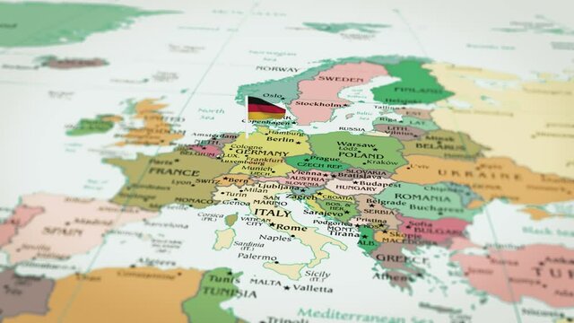 Animation video of Germany on the map and approaching its flag. Shot of the red Germany flag with a waving star in focus in high resolution. Which has borders and neighboring countries.