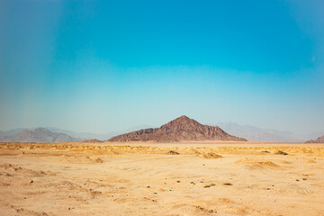 Egyptian dessert in sunny day background. African hills and mountains. Tourist Arabian destination.