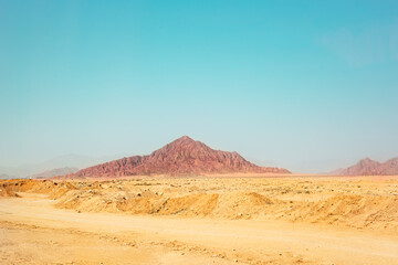 Egyptian dessert in sunny day background. African hills and mountains. Tourist Arabian destination.