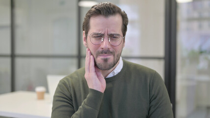 Portrait of Sick Young Businessman having Toothache