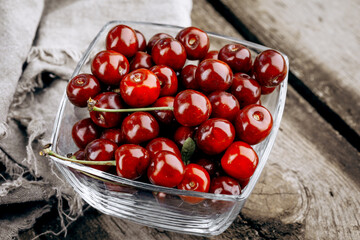 Ripe red cherries on a wooden table