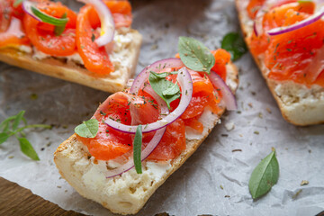 Sandwich with smoked salmon and cream cheese on a crispy baguette