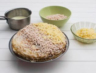 Lasagna's assembly on a white table.