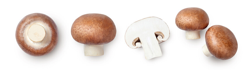 Whole and sliced brown champignons isolated on white background. Top view.