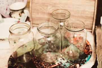 Clean glass jars on tray on kitchen table