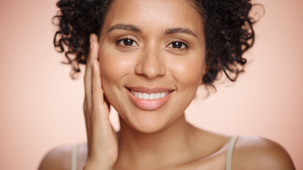 Female Beauty Portrait. Beautiful Black Multiethnic Latina Woman with Afro Hair Posing, Touching...