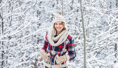 Fototapeta premium Winter admirer. Favorite season. Walk in snowy forest. Cheerful emotional girl having fun outdoors. Winter outfit. Woman wear warm accessories stand in snowy nature. Winter fashion collection