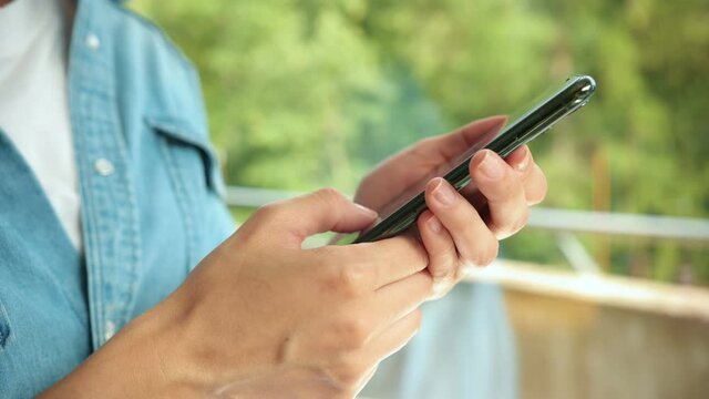 Close up of beautiful caucasian woman typing on phone at home. Health care, authenticity, sense of balance and calmness. Work from home.